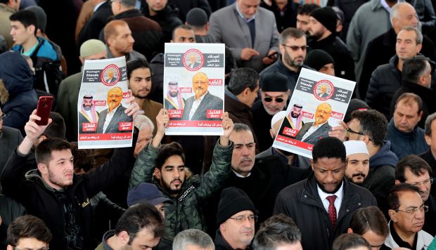 Hombres sostienen una imágenes del periodista opositor saudí Jamal Khashoggi mientras rezan en la mezquita Fatih, en Estambul. (Foto: EFE)